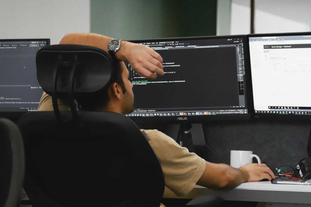 person coding at desk
